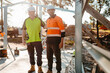 © Austockphoto - Construction workers looking at the construction site.