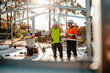 © Austockphoto - Two construction site managers looking at digital blueprints on worksite