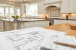 © TesaI - Architectural blueprints on kitchen island. Bright, modern kitchen in background. Natural light. Home renovation or construction planning concept