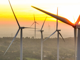 Wind farm field and sunset sky. Wind power. Sustainable, renewable energy. Wind turbines generate electricity. Sustainable development. Green technology for energy sustainability. Eco-friendly energy.