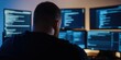 © gunzexx png and bg - A man is seated in a dimly lit room facing several computer screens filled with code, suggesting cybersecurity or programming activities taking place.