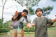 © Odua Images - a boy catches bubbles while playing with dad at the park in the afternoon