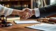 © Xabi - A professional lawyer shaking hands with her client over an office desk with documents and a gavel with law books background, Bribery, Concept lawyer, and legal