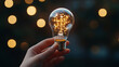 © VERTEX SPACE - A hand holding glowing light bulb with warm bokeh lights in background creates magical and inspiring atmosphere. intricate design of bulb showcases its beauty and innovation