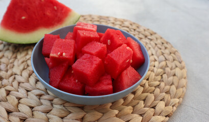 A bowl of fresh watermelon served on white bowl on wooden image. Breakfast fruit in the morning, healthy for the body.