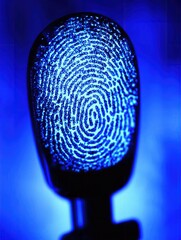 Blue illuminated fingerprint on a microphone, symbolizing security and identity.