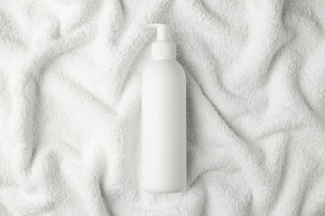 Canvas Print - Bottle of shampoo on soft terry towel, top view