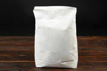 Canvas Print - Bag of cement powder on wooden table. Building material