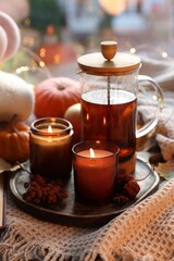 Wall Mural - Burning candles, freshly brewed tea and autumn decor on fabric