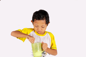 Handsome Indonesian boy, enjoying eating ice cream in a glass