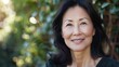 © ANC Media - A cheerful Asian woman poses in natural light, creating a positive and inviting atmosphere