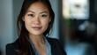© Ananncee Media - A young Asian woman poses confidently in natural light, showcasing her professional demeanor