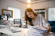 © PaeGAG - Stressed businesswoman overwhelmed by paperwork in office, struggling to meet deadline. Balancing career challenges in corporate world