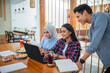 © Odua Images - Group of indonesian students studying together using laptop in the coffee shop