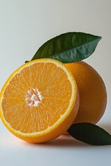 Wall Mural - Freshly sliced oranges with vibrant color resting on green leaves against a light background