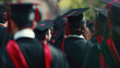 © KirKam - Group of graduates in gowns and caps celebrating their achievement with smiles and diplomas in hand, standing in front of university building.