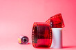 © wdnld - Red Film Strip Unwinding on Pink Background