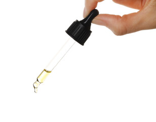 Sticker - Essential oil dripping from pipette against white background