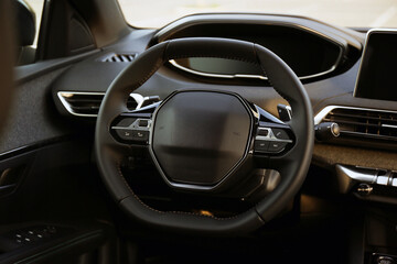 Wall Mural - Steering wheel and dashboard inside of modern luxury car, closeup