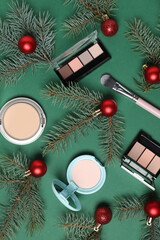 Wall Mural - Flat lay composition with makeup products and Christmas decor on green background