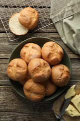 Poster - Homemade tasty buns, butter and knife on wooden table, flat lay