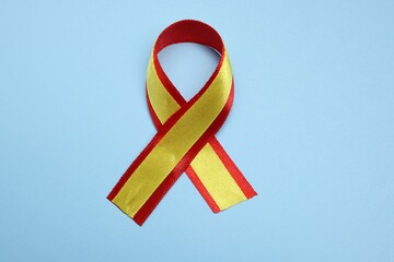 Canvas Print - One yellow and red ribbon on light blue background, top view. Hepatitis C awareness