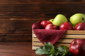 Poster - Ripe red and green apples in crate on wooden table, space for text