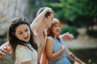 © qunica.com - Group of friends enjoying a sunny outdoor setting, sharing laughter and joy. Young people reveling in happiness and friendship in a natural summer environment.
