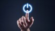 © BoOm - Hand pressing glowing power button on dark background, symbolizing technology activation.