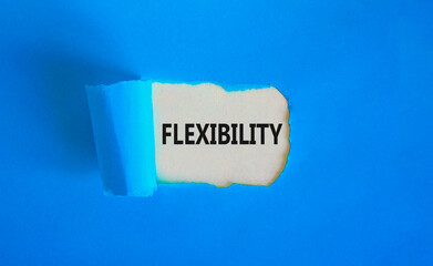 Wall Mural - Flexibility symbol. Concept word Flexibility on beautiful white paper. Beautiful blue paper background. Business flexibility concept. Copy space.