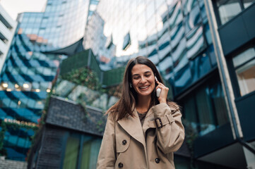 Elegant businesswoman talking on the phone walking in the city