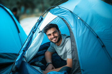 young handsome man inside a camping tent