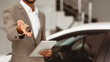 © Prostock-studio - Automobile Sales. Unrecognizable Seller Guy Offering Car Key Selling Auto In Dealership Store. Panorama, Cropped, Selective Focus