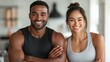 © Art_You - Happy athletic man and woman smiling confidently in workout attire, showcasing fitness and positivity in a bright gym environment
