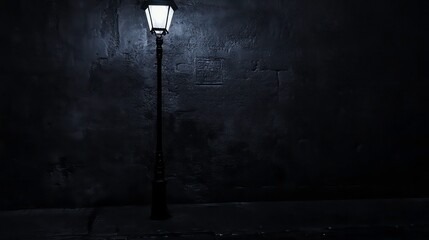 A single street lamp illuminates a dark alleyway with a rough stone wall.