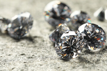 Sticker - Many beautiful shiny diamonds on grey table, closeup