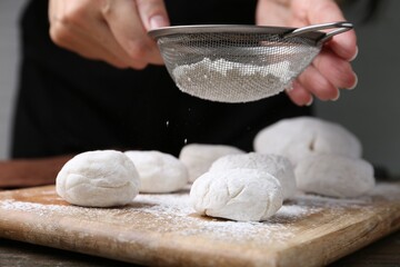 Sticker - Woman making tasty mochi at wooden table, closeup