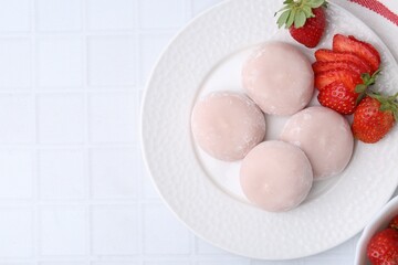 Canvas Print - Delicious mochi and strawberries on white tiled table, top view. Space for text