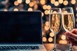 © Konstiantyn Zapylaie - Celebratory toast with champagne glasses and laptop with festive bokeh lights