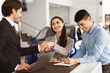 © Prostock-studio - Young Spouses Buying Car, Beautiful Wife Handshaking With Seller Man Standing In Dealership Office. Selective Focus