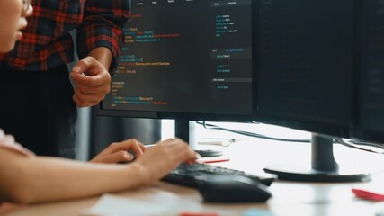 Slow motion back end or software developer manager supervising his team on new application program development on debugging and solving complex code algorithms on monitor. Burgeoning