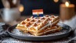 © Generative AI - Waffles with icing sugar and Belgium flag on a plate Grey background : Generative AI