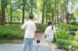 © Yoshida - A 1 year old Taiwanese girl walking hand in hand with her parents, a man and woman in their 20s, on a hot sunny day in the streets of Taichung City, Taiwan, in September.