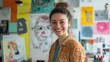 © jureephorn - Smiling female artist looks confidently at camera Surrounded by her creative tools and sketches Vibrant energy of the workspace