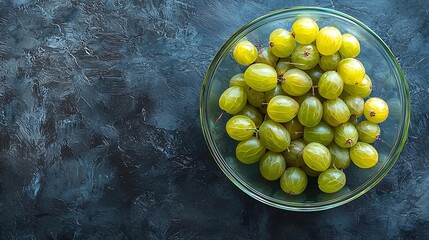 Poster - Gooseberries in glass bowl on black stone slate background Top view Copy space : Generative AI