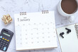 © Yuphayao Pooh's - Top view of January 2025 calendar. January 2025 calendar and cup of coffee, calculator, wireless headphones on the table. Happy new year 2025 concept