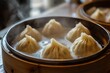 © NatthaphonSiri - Steaming Hot Dumplings in a Bamboo Steamer.