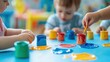 © Nany - Children participating in an arts and crafts activity at daycare, creating colorful projects with paint and paper