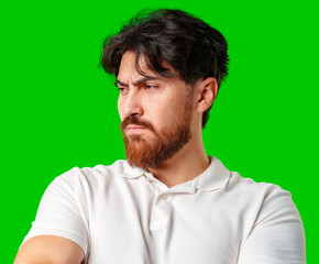 A man with a serious expression stands with crossed arms against a vibrant green background