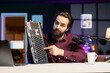 © DC Studio - Influencer in studio reviewing gaming keyboard. Online show host filming electronics haul, presenting bluetooth wireless computer peripheral to viewers during live broadcast